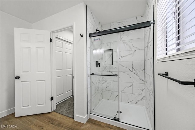 bathroom featuring wood-type flooring and a shower with door