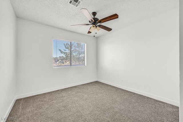 carpeted spare room with ceiling fan and a textured ceiling