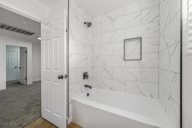 bathroom featuring hardwood / wood-style flooring and tiled shower / bath