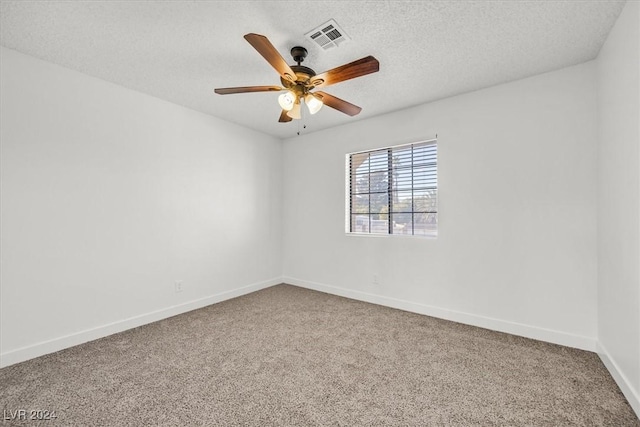 carpeted spare room with ceiling fan and a textured ceiling