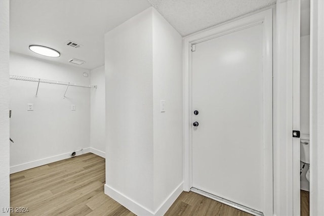 laundry room with light hardwood / wood-style flooring