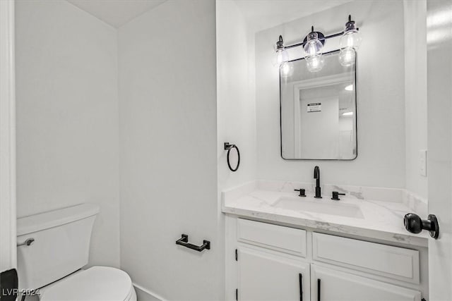 bathroom featuring toilet and vanity