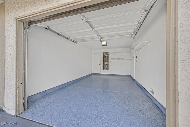 garage with a garage door opener and strapped water heater