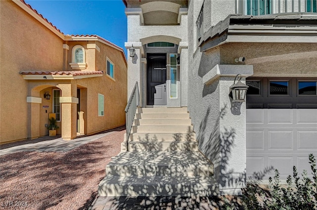 view of exterior entry with a garage