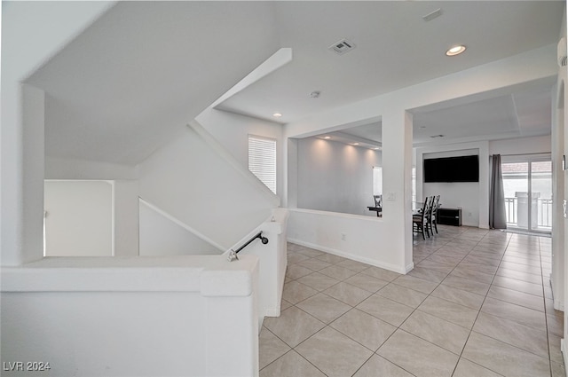 corridor featuring light tile patterned floors