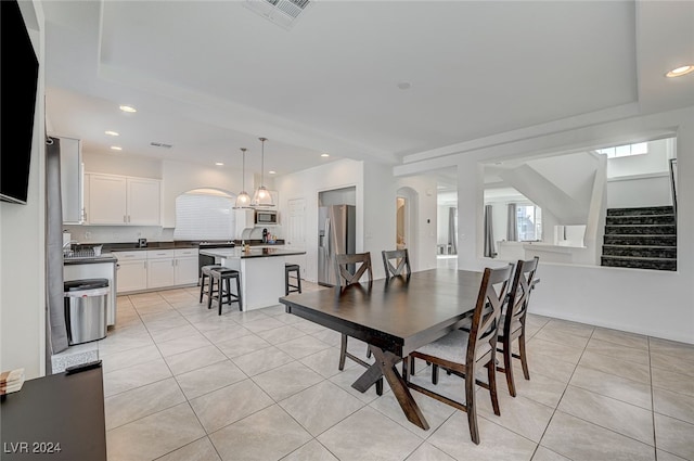 tiled dining area with a notable chandelier