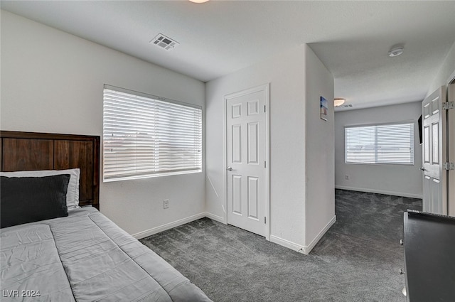 bedroom with dark carpet