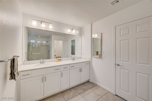 bathroom with vanity, an enclosed shower, and tile patterned flooring