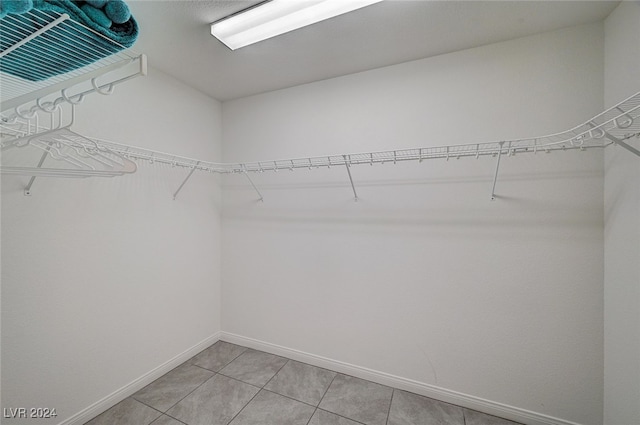 spacious closet featuring light tile patterned floors