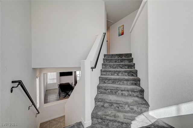 stairs with tile patterned floors