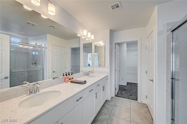 bathroom featuring vanity, walk in shower, and tile patterned flooring