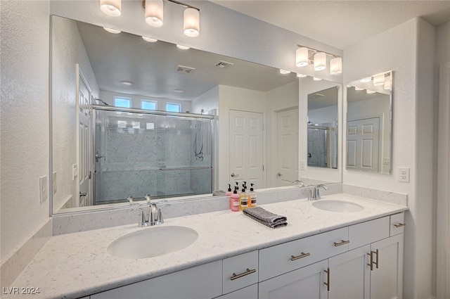 bathroom with vanity and an enclosed shower