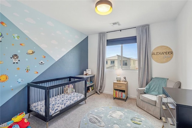 bedroom featuring a nursery area and carpet