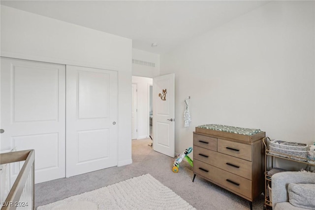 carpeted bedroom with a closet