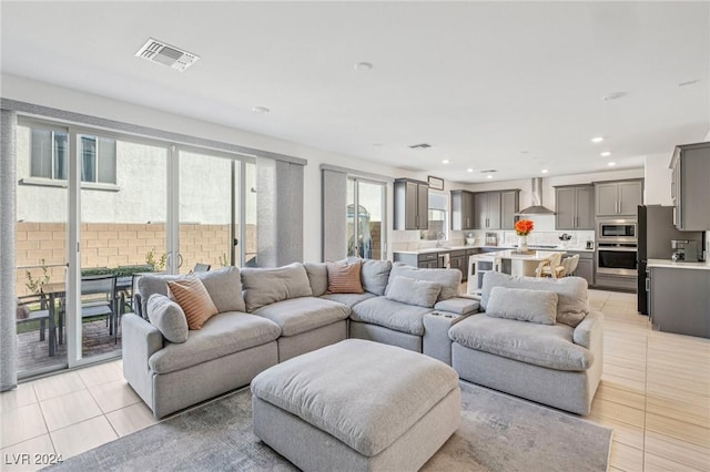 living room with sink and light tile patterned floors