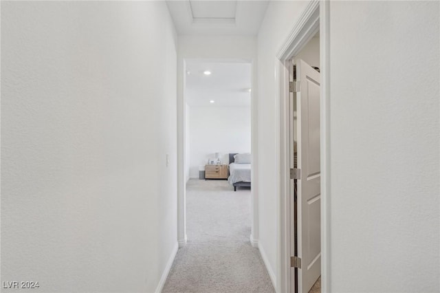 corridor with light colored carpet