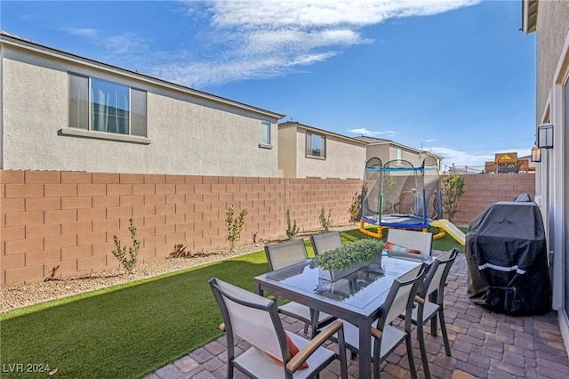 view of patio / terrace featuring a grill and a trampoline