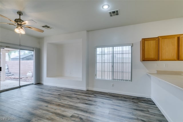 unfurnished dining area featuring hardwood / wood-style floors and ceiling fan