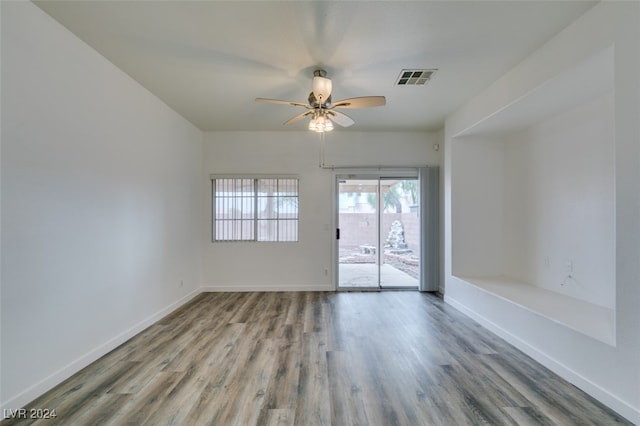 unfurnished room with ceiling fan and hardwood / wood-style floors