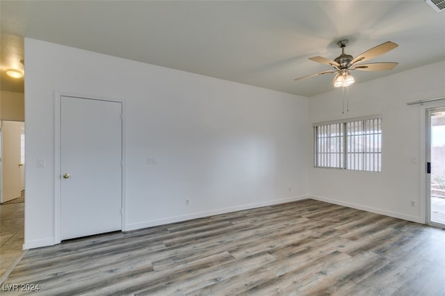 empty room with ceiling fan and light wood-type flooring