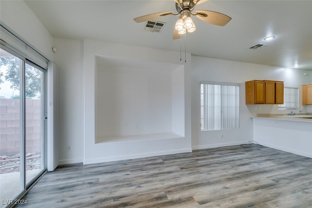 interior space with sink, light hardwood / wood-style floors, and ceiling fan