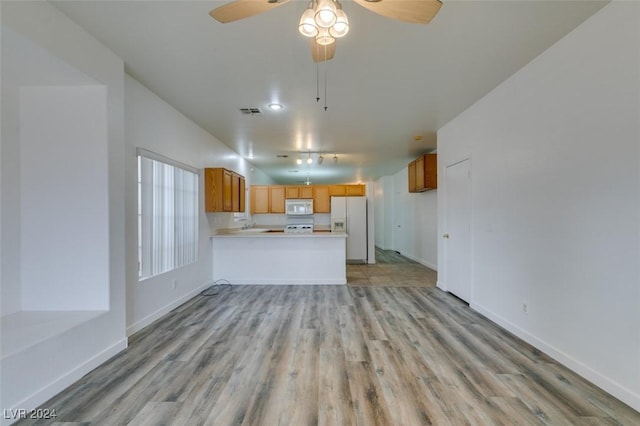 6214 Osaka Pearl St, North Las Vegas, NV 89031 - unfurnished living room with light wood-style floors and a ceiling fan