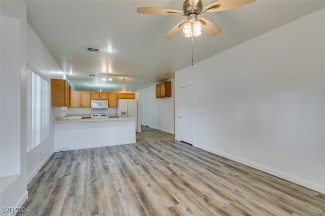 interior space with ceiling fan and light wood-type flooring