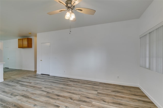 spare room with light hardwood / wood-style flooring and ceiling fan