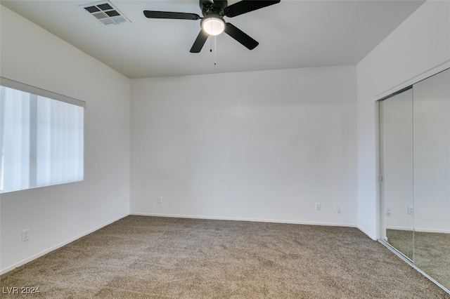 unfurnished bedroom with carpet flooring, a closet, and ceiling fan