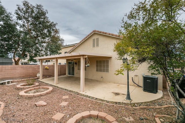 rear view of house with a patio, an outdoor fire pit, and cooling unit