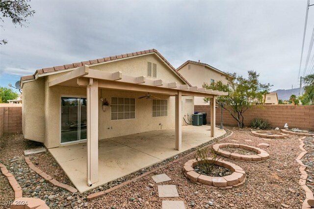 6214 Osaka Pearl St, North Las Vegas, NV 89031 - back of house with a ceiling fan, a fenced backyard, stucco siding, a patio area, and an outdoor fire pit
