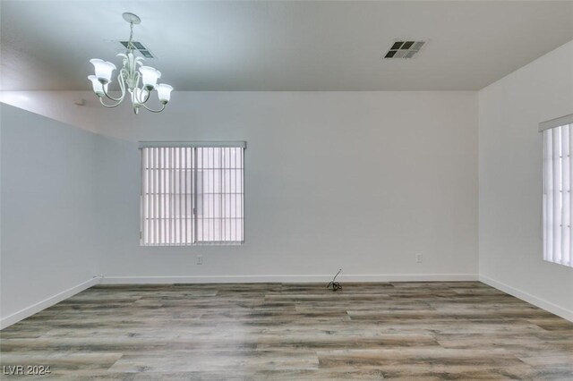 6214 Osaka Pearl St, North Las Vegas, NV 89031 - empty room with a chandelier and wood finished floors