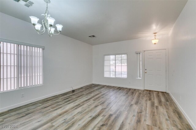 6214 Osaka Pearl St, North Las Vegas, NV 89031 - spare room featuring wood finished floors and a chandelier