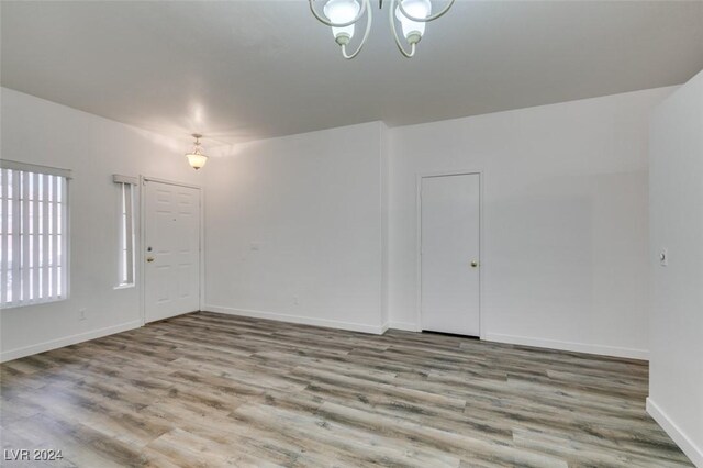 6214 Osaka Pearl St, North Las Vegas, NV 89031 - unfurnished room with a chandelier and wood finished floors