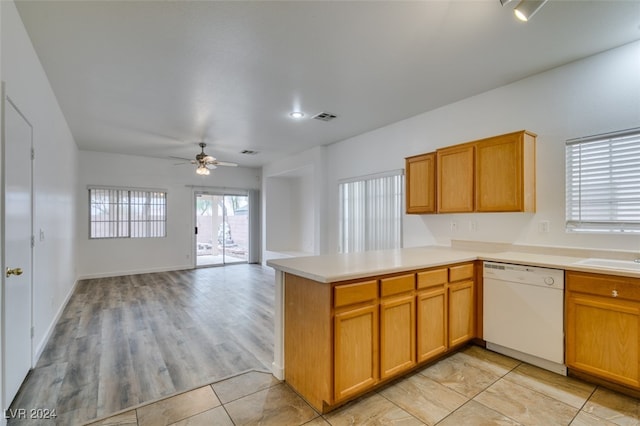 kitchen with dishwasher, kitchen peninsula, light wood-type flooring, and ceiling fan