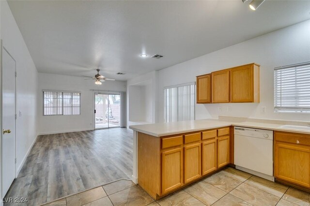 6214 Osaka Pearl St, North Las Vegas, NV 89031 - kitchen featuring white dishwasher, a ceiling fan, a peninsula, light countertops, and open floor plan