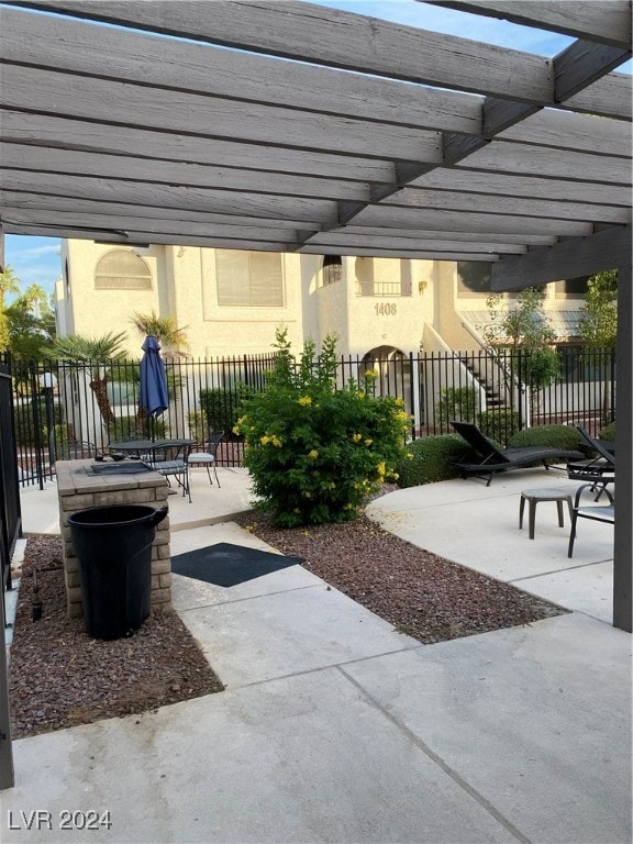 view of patio featuring a pergola and a fire pit