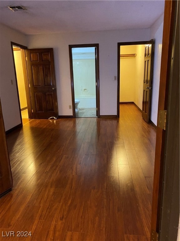 unfurnished room with wood-type flooring