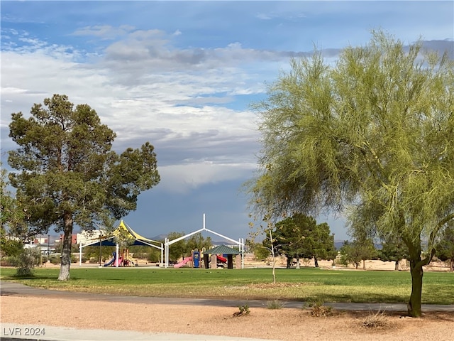 view of property's community featuring a yard and a playground