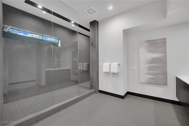 bathroom featuring walk in shower and vanity