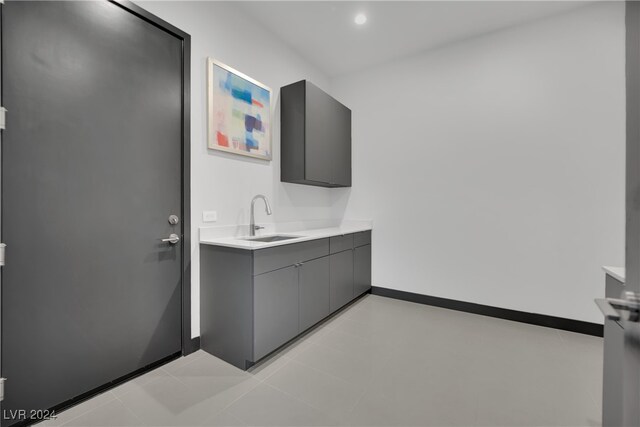 interior space featuring light tile patterned floors and sink