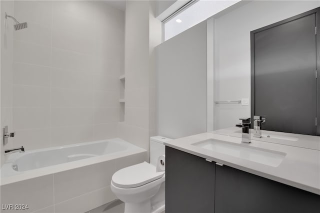 full bathroom featuring vanity, toilet, and tiled shower / bath