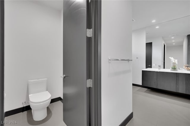 bathroom with vanity, tile patterned flooring, and toilet