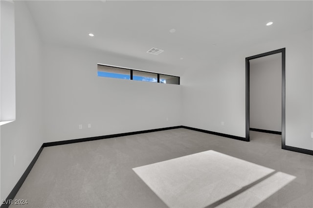 unfurnished room with light carpet