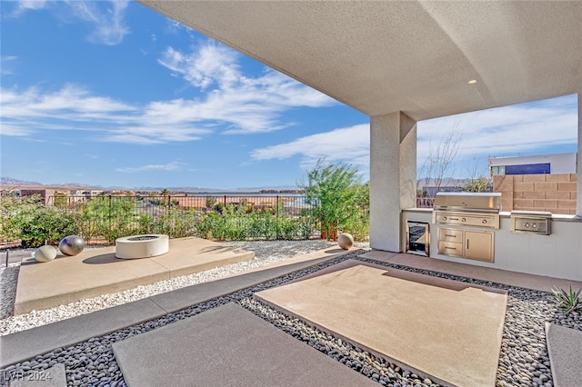 view of patio with grilling area and an outdoor kitchen