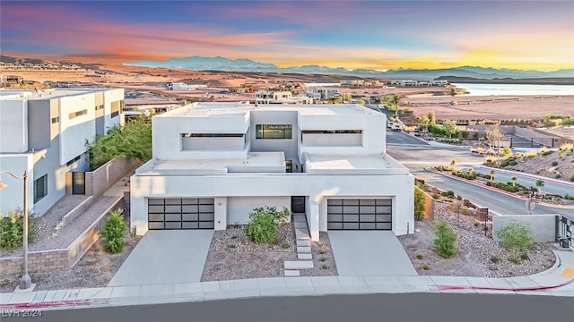 view of front of property with a mountain view and a garage