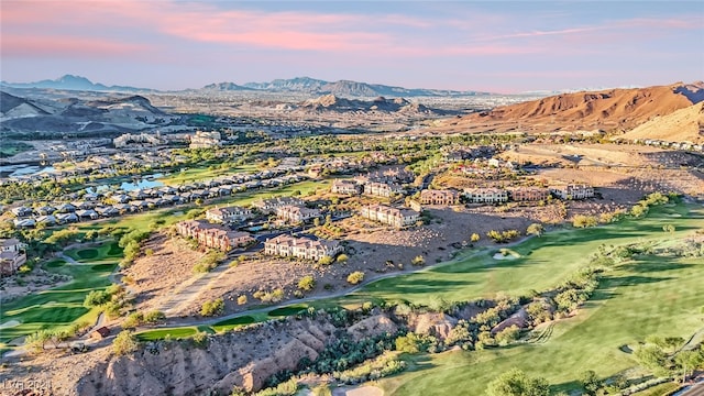 aerial view at dusk featuring a mountain view