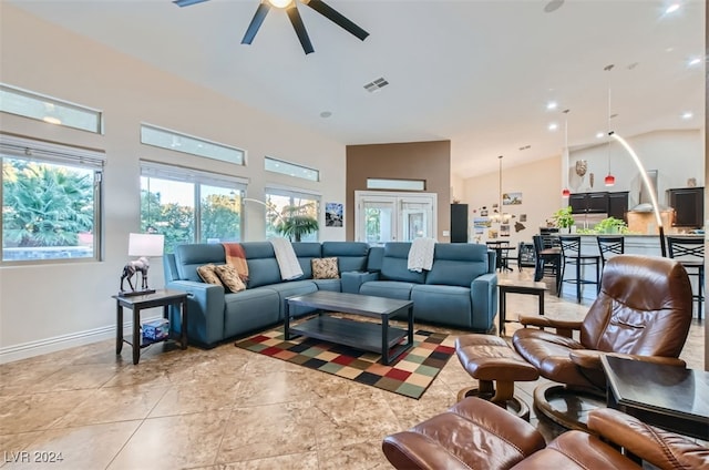 living room with high vaulted ceiling, a wealth of natural light, and ceiling fan