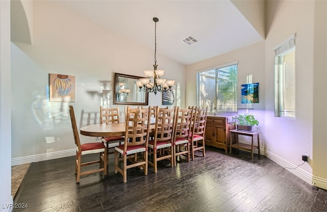 dining area featuring lofted ceiling, an inviting chandelier, and dark hardwood / wood-style flooring