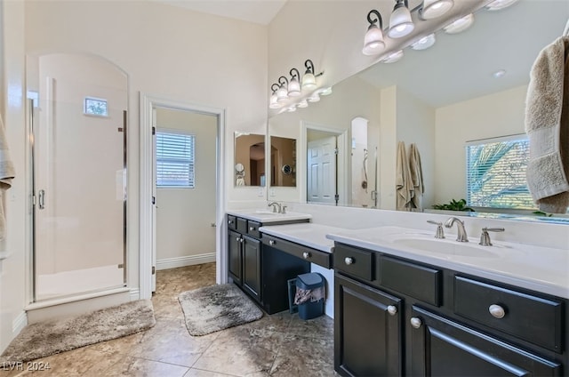 bathroom with vanity and a shower with door